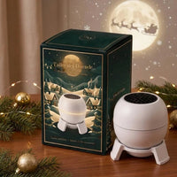 Proyector Taller del Duende junto a su caja de regalo con la luna y el trineo de Papá Noel
